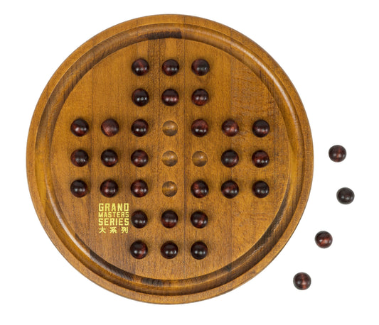 Wooden solitaire puzzle board with dark wood pegs arranged in holes, four loose pegs shown beside