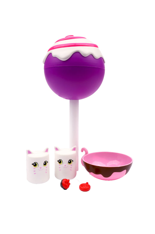 Cakepop Cuties Jumbo Surprise playset with purple lollipop-shaped squishy, two white cat-faced containers, pink bowl, and red fruit accessories