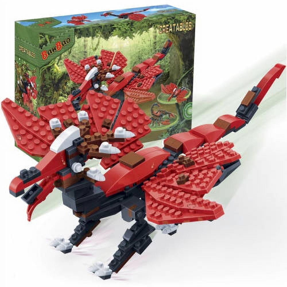 Red and black buildable raptor dinosaur figure with articulated limbs and wings, shown assembled next to its packaging box