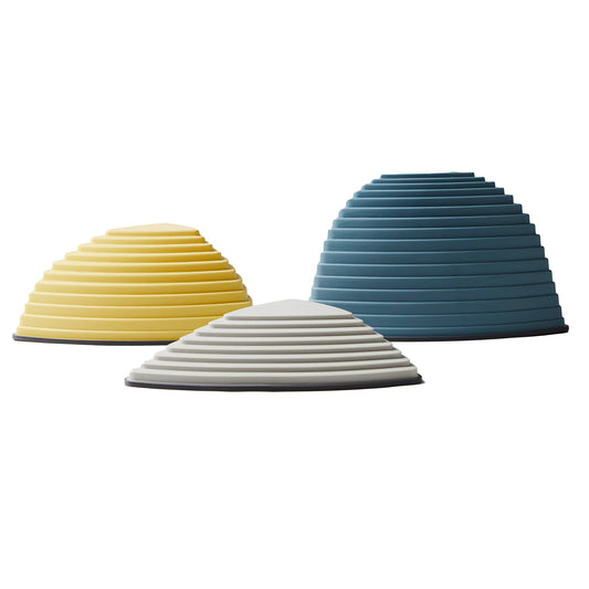 Set of three GONGE Hilltops stepping stones in yellow, gray, and teal with textured ribbed surfaces and black bases on white background