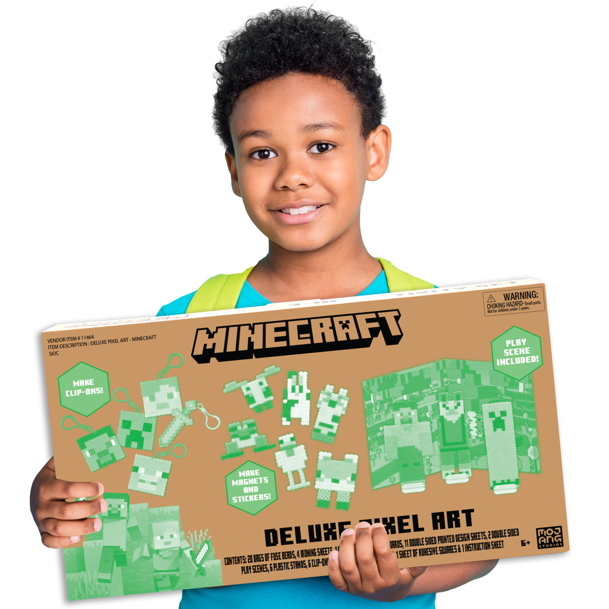Boy holding Minecraft Deluxe Pixel Art box featuring green and white fuse bead characters and designs