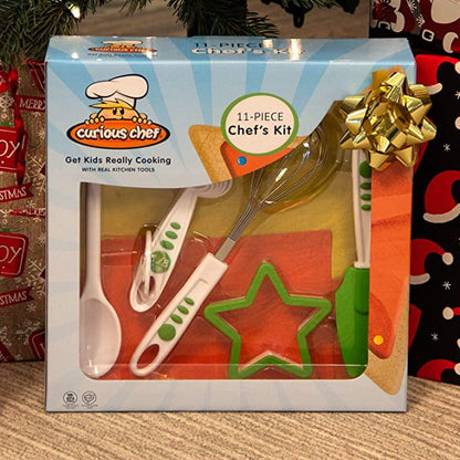Curious Chef 11-Piece Chef's Kit featuring child-sized cooking utensils including whisk, spatula, and star-shaped cookie cutter in red, white, and green