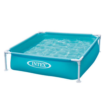 Intex mini frame pool with turquoise vinyl walls, white metal legs, and clear water with ripple reflections