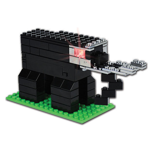 Black building blocks assembled into a cave structure with green baseplate and detachable silver and red panel pieces