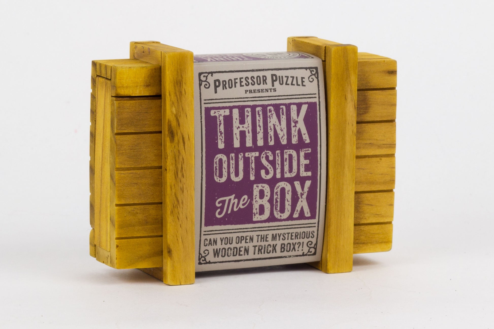 Yellow wooden trick box with label reading 'Professor Puzzle Presents Think Outside The Box - Can You Open The Mysterious Wooden Trick Box?'