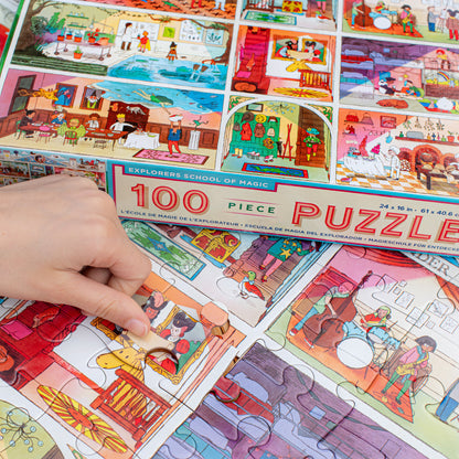 100 Piece Puzzle Explorers School of Magic with colorful illustrated scenes being assembled by hand