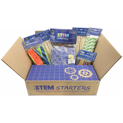 STEM Starters kit in open cardboard box containing multiple blue STEM Basics packages, wooden sticks, colorful straws, craft materials, and a blue instruction s