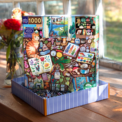 Piece&Love Naturalist's Cat 1000 piece puzzle box featuring orange cat and colorful art supplies
