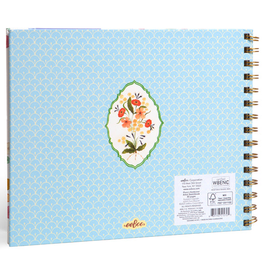 Light blue spiral-bound sketchbook with scallop pattern, featuring a floral bouquet in a green frame on the cover