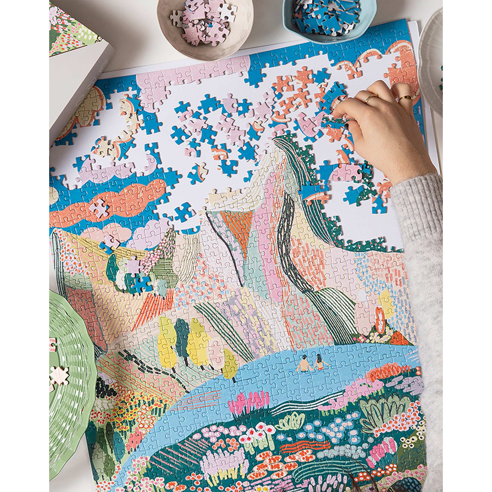 Journey Of Something Laguna 1000-Piece Jigsaw Puzzle with colorful landscape design being assembled