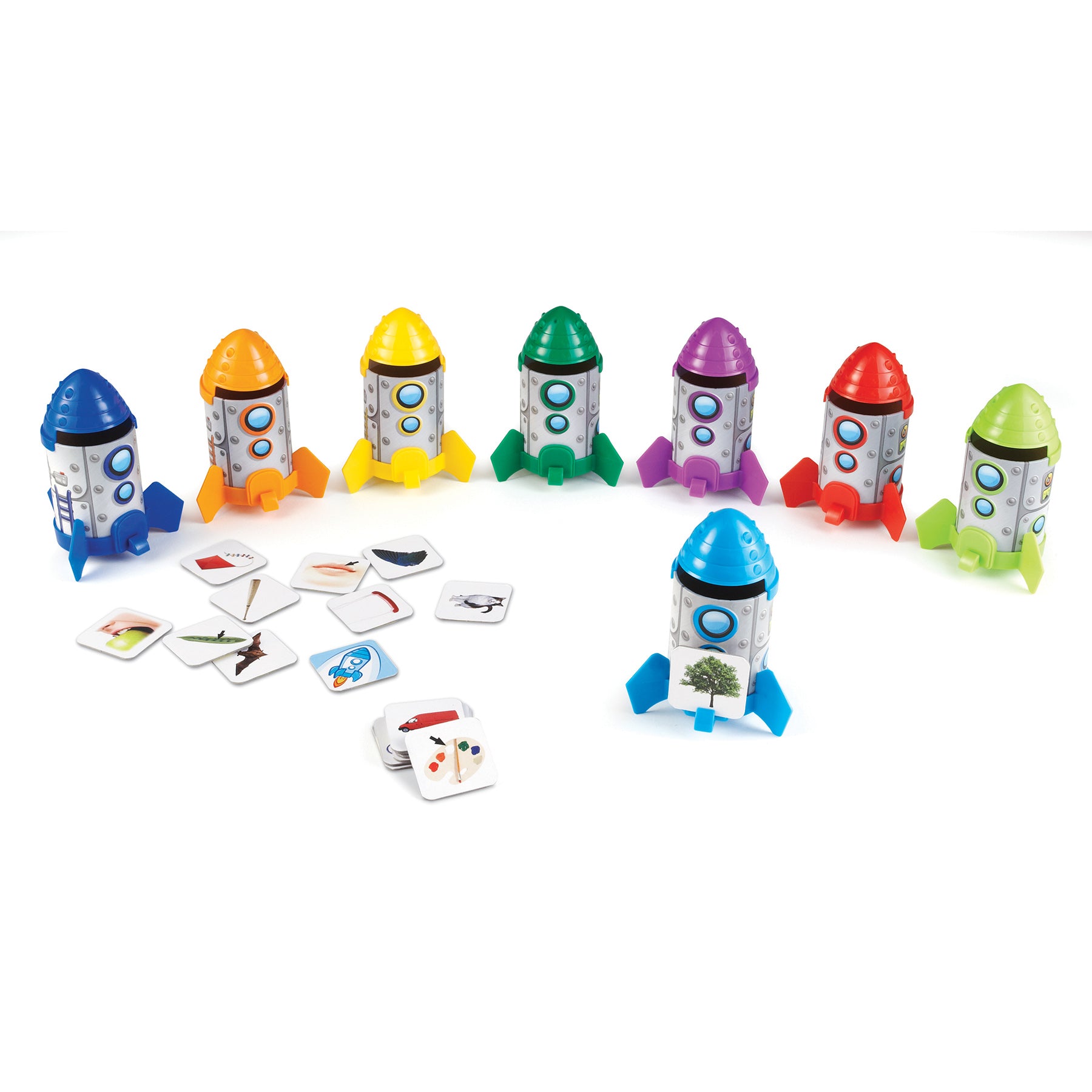 Seven colorful toy rockets with colored domes in blue, orange, yellow, green, purple, red, and lime green, each with gray bodies and circular windows, arranged