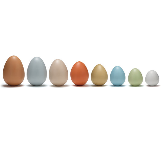 Eight smooth plastic eggs in brown, gray, beige, orange, gold, blue, green, and white, arranged in a row on white background