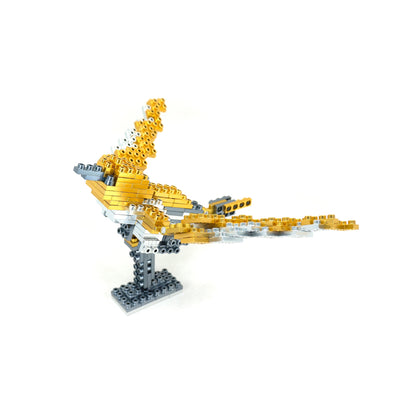 Yellow and gray modular building blocks assembled into an eagle or bird figure with outstretched wings on a stand