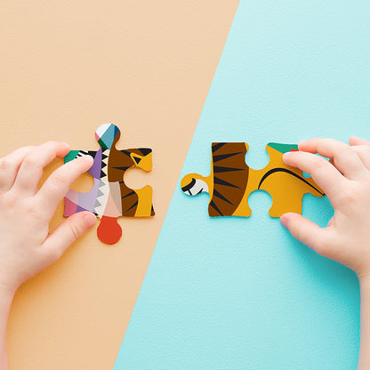 JOS 24 Piece Puzzle Animal Carnival with colorful tiger pieces being assembled by hands