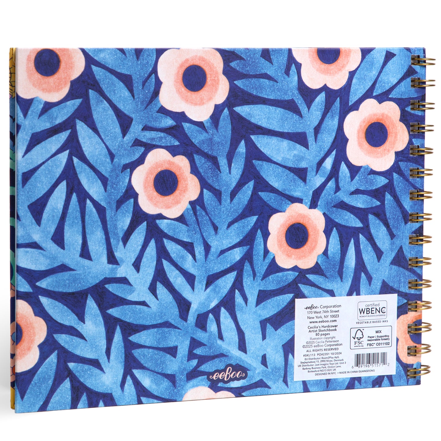 Spiral-bound artist sketchbook with blue foliage and coral flower pattern cover, gold binding visible on spine