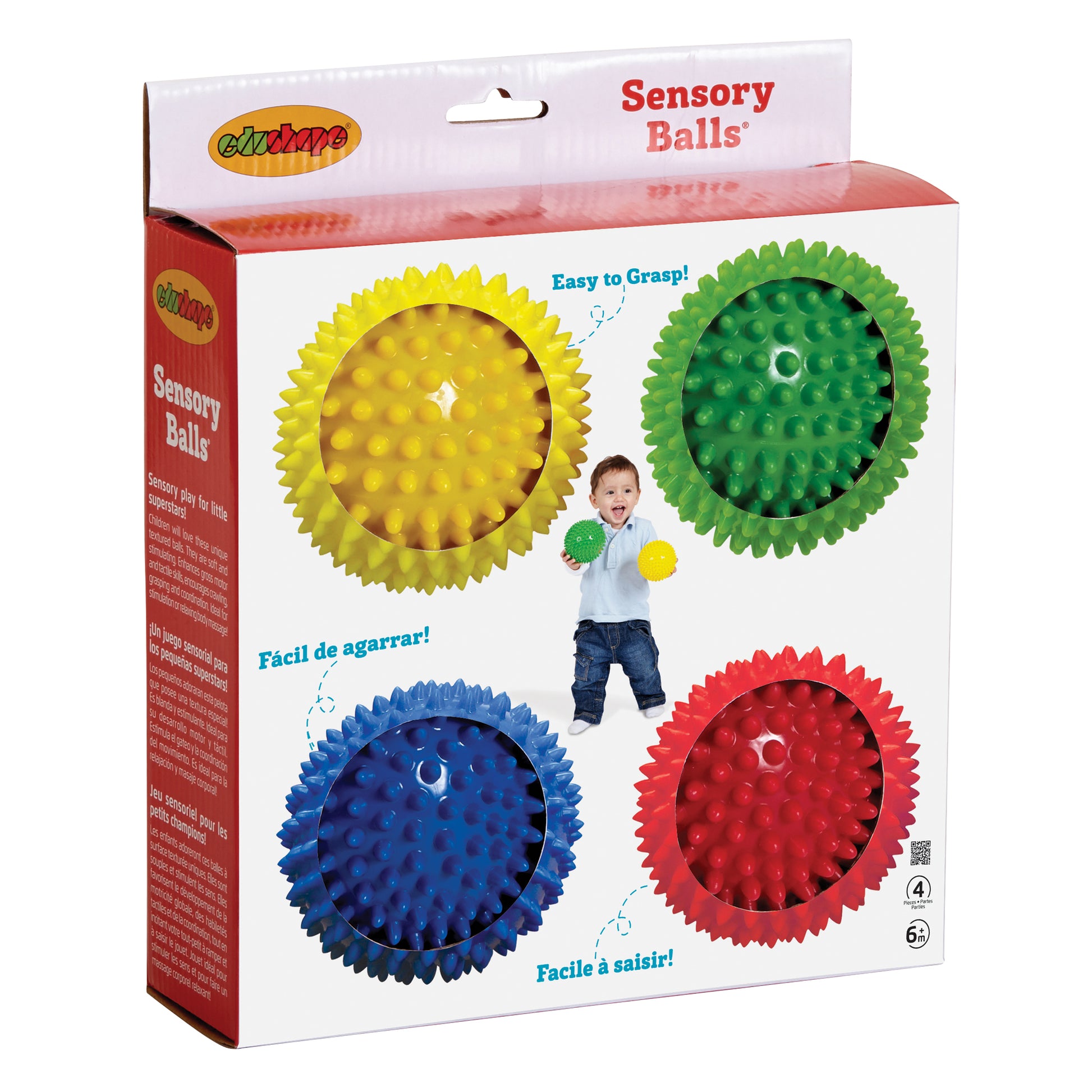 Four spiky sensory balls in yellow, green, blue, and red, displayed in packaging with a toddler on model holding a green ball