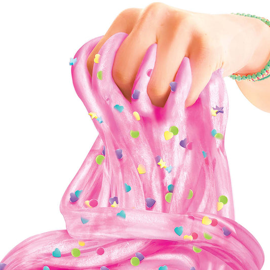 Hand stretching pink slime with colorful heart and circle embellishments