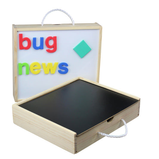 Wooden activity box with white magnetic board displaying colorful magnetic letters spelling 'bug news' and a turquoise diamond shape, with chalkboard surface on