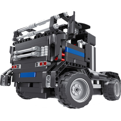 Black and silver motorized building block truck with articulated crane arm, blue accents, and large wheels on plain background
