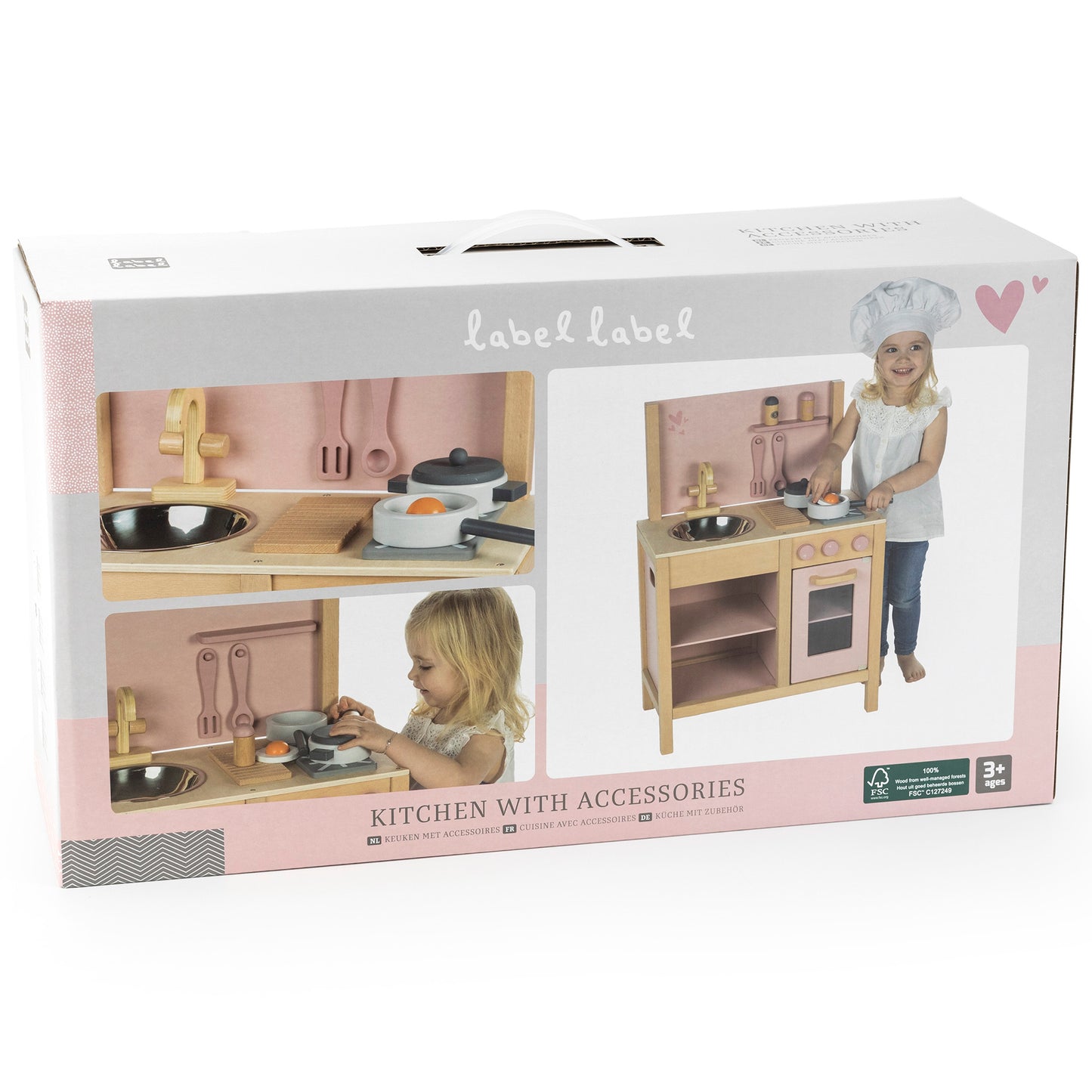 Label Label wooden play kitchen with pink and natural wood finish, includes stove, oven, sink, and metal cooking accessories, shown on packaging with child mode