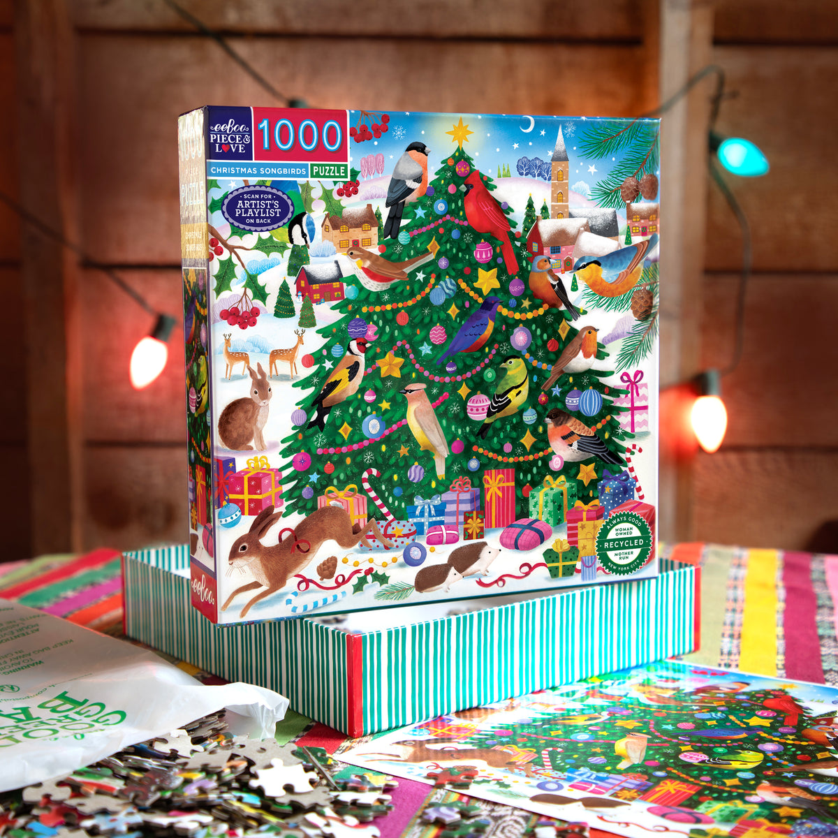 eeBoo Christmas Songbirds 1000 Piece Puzzle box featuring colorful birds on decorated Christmas tree with gifts and snow