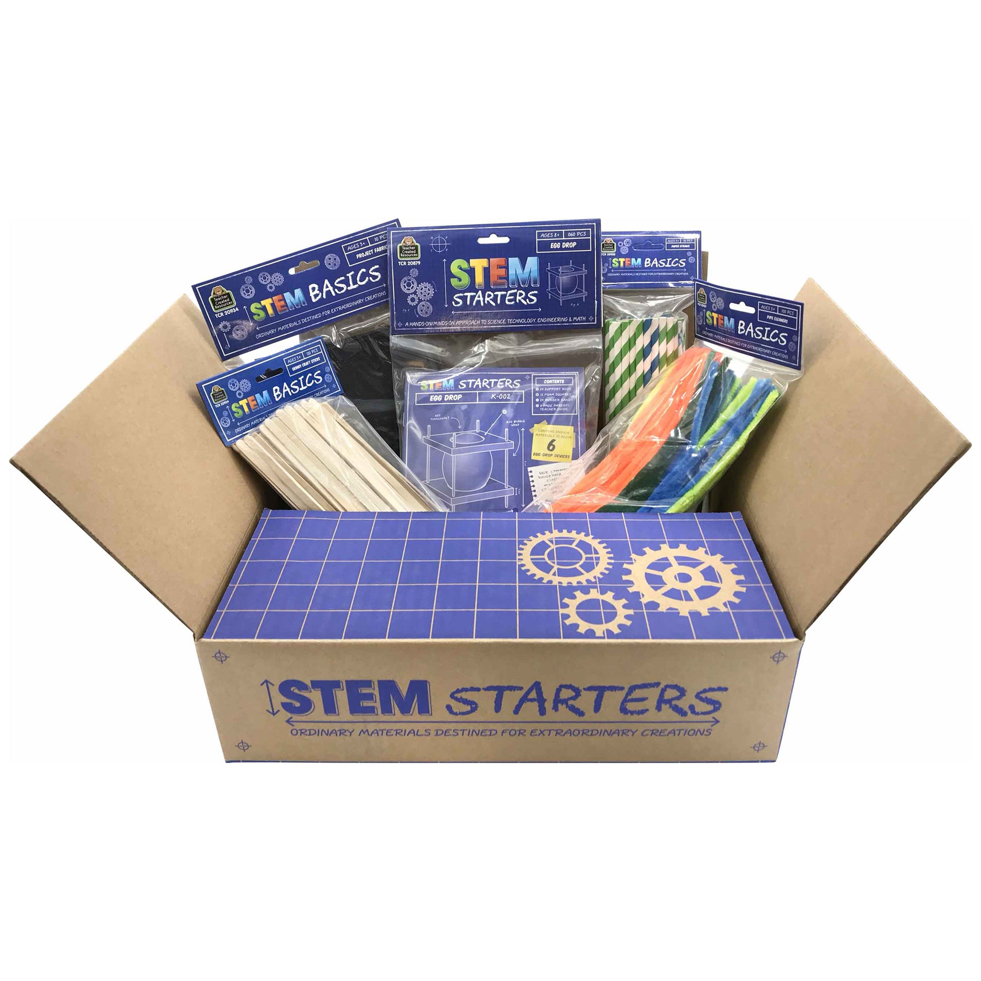 STEM Starters kit box open showing assorted building materials including wood sticks, colorful straws, green and white striped paper, and blue instruction cards
