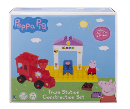 Peppa Pig Train Station Construction Set with red train, station building, yellow track base, Peppa figure, and building blocks on package display