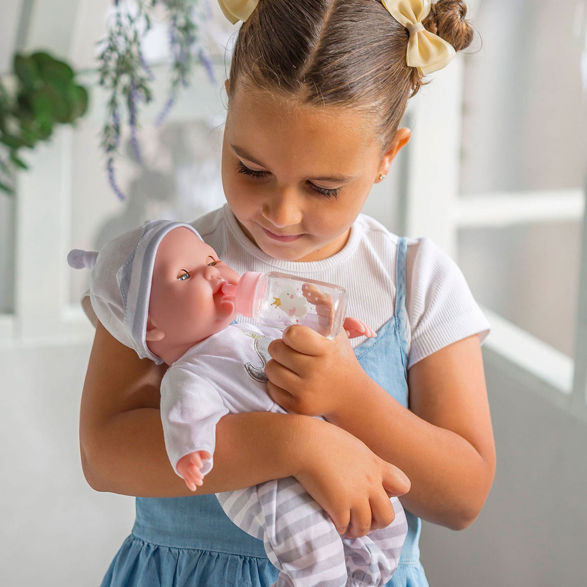 JC Toys Nonis Boutique 15" baby doll with grey eyes, soft body, includes bottle and pacifier