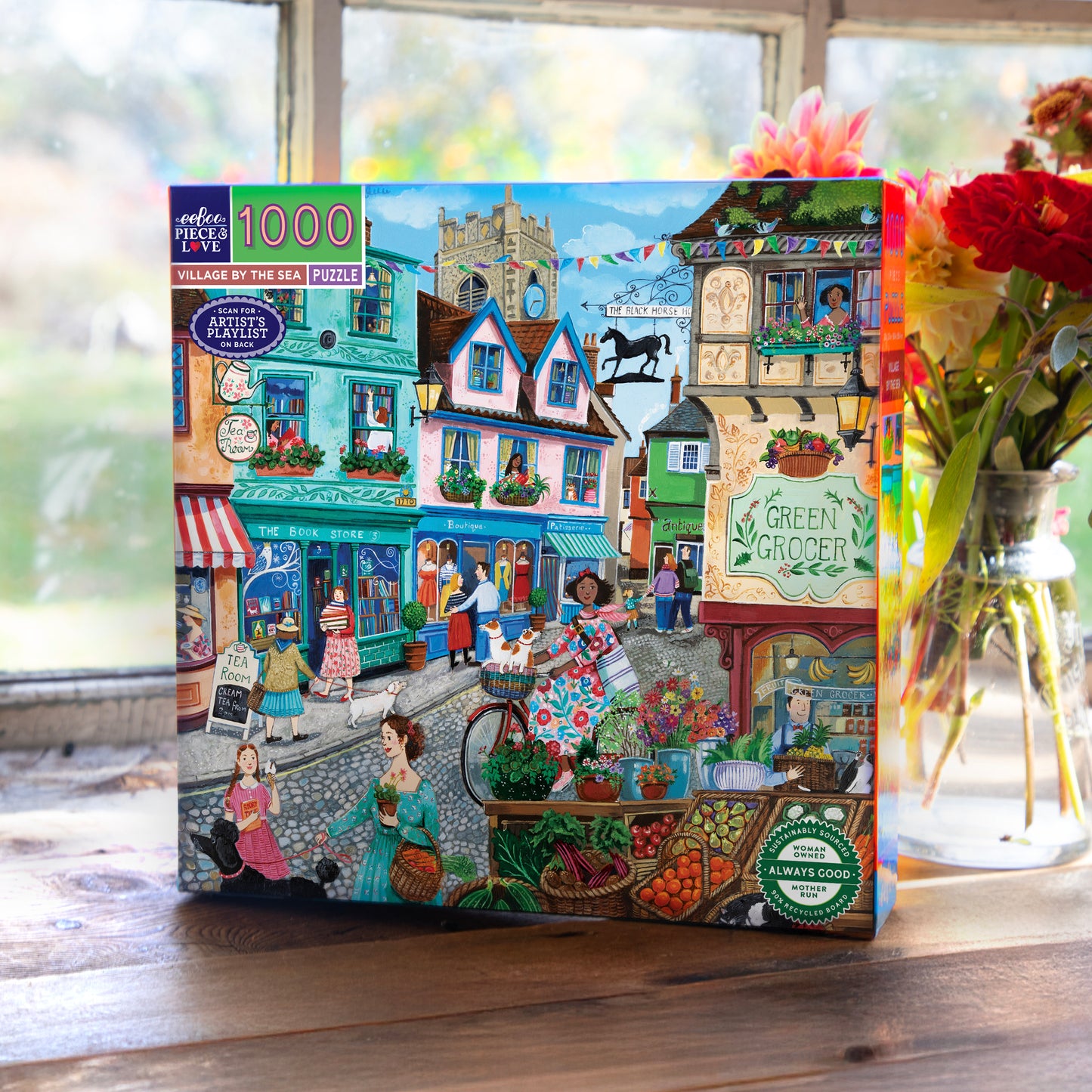 eeBoo Village By The Sea 1000-Piece Puzzle featuring colorful seaside village shops and characters