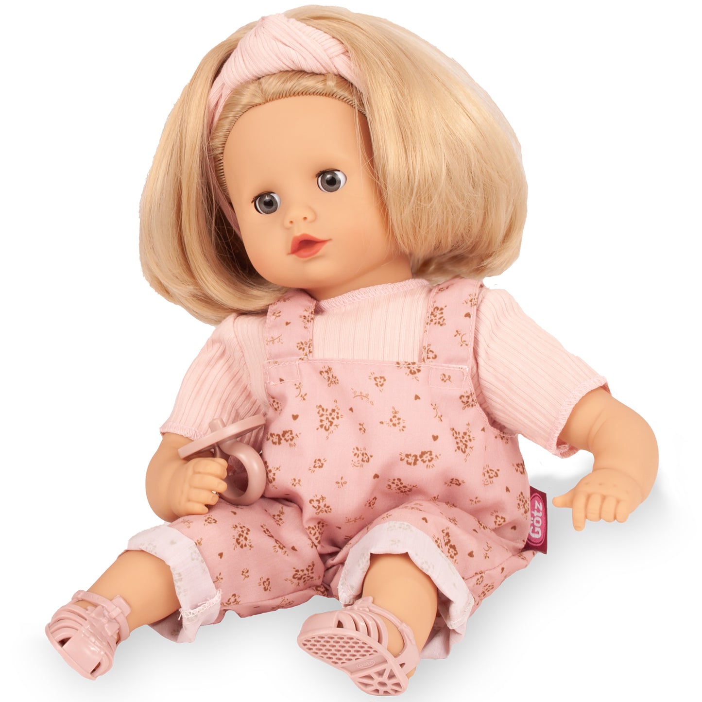 Gotz Muffin 13" doll with blonde hair, pink floral overalls, and matching headband