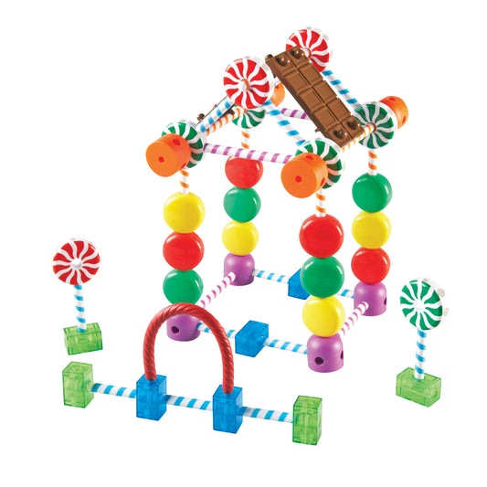 Candy-themed building set with colorful beads, striped connectors, peppermint lollipops, chocolate bar piece, and green base blocks forming an abstract structur