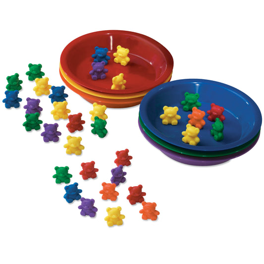 Colorful plastic bear counters in red, yellow, blue, green, purple, and orange arranged around three nesting bowls in red, blue, and purple