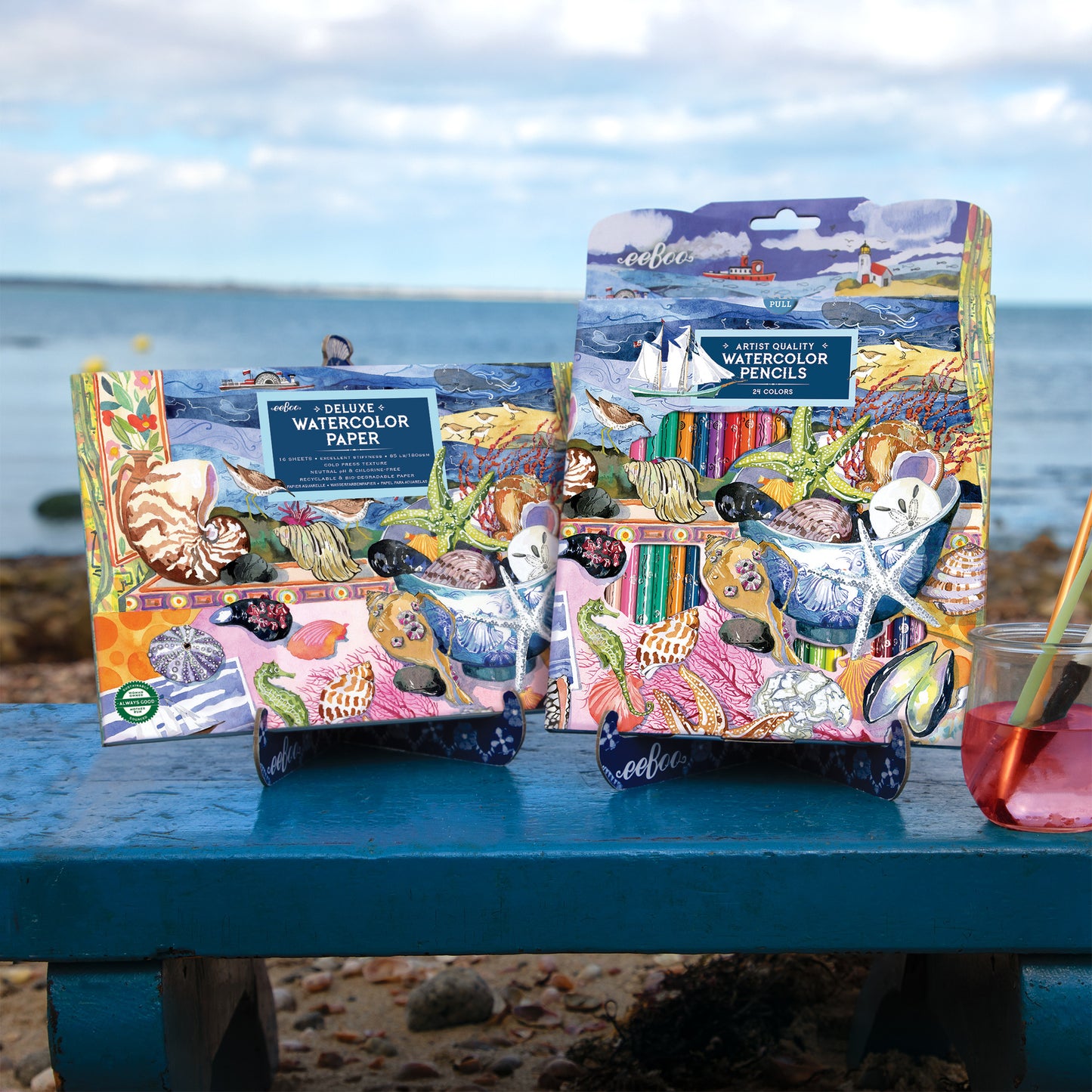 eeBoo Seashells Watercolor Pad with colorful pencils displayed on beach table