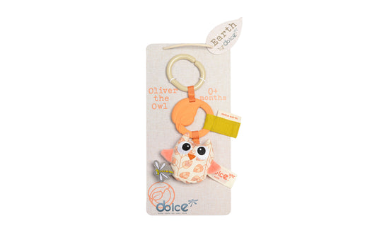 Oliver the Owl plush toy attached to beige packaging card with wooden ring, orange teether ring, and yellow textured tag, for ages 0+ months
