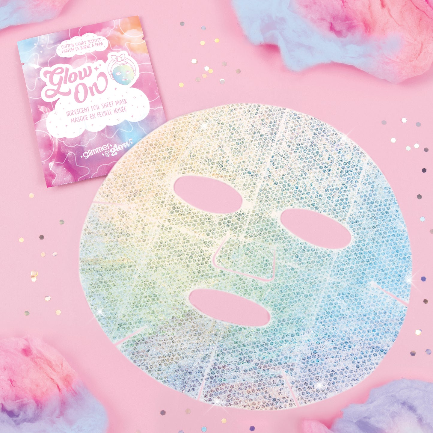 Glimmer & Glow iridescent foil sheet mask with three oval cutouts on pink background