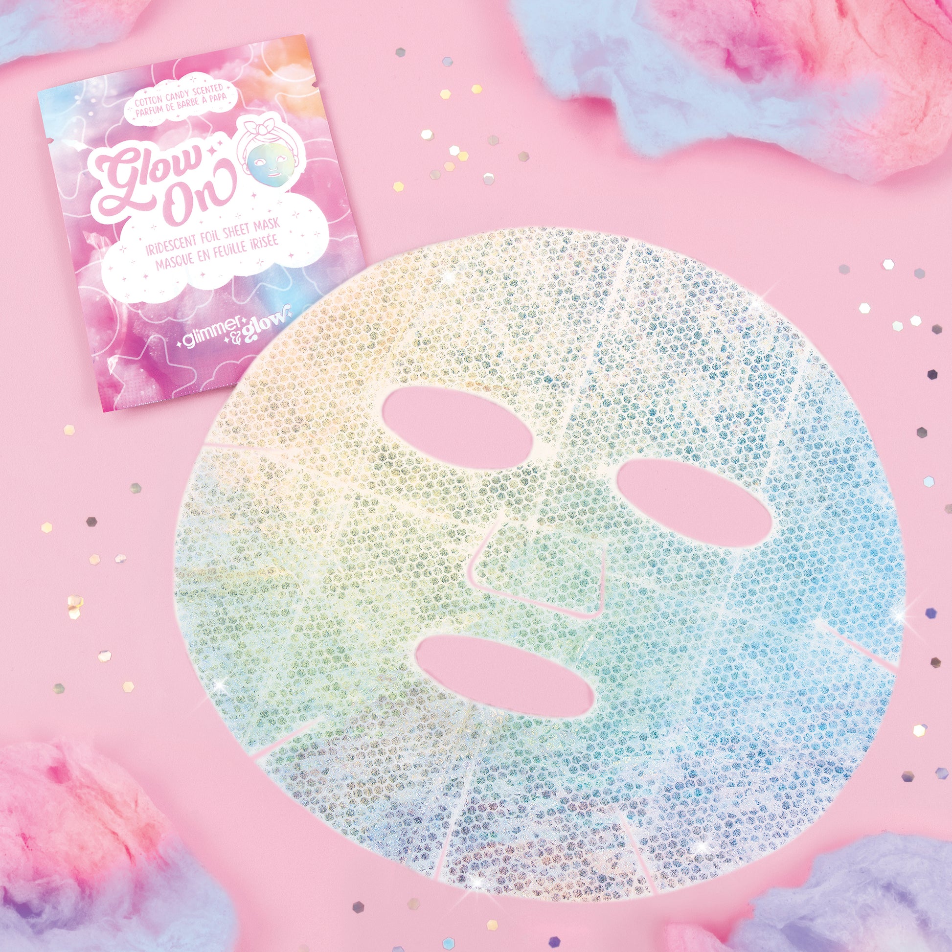 Glimmer & Glow iridescent foil sheet mask with three oval cutouts on pink background