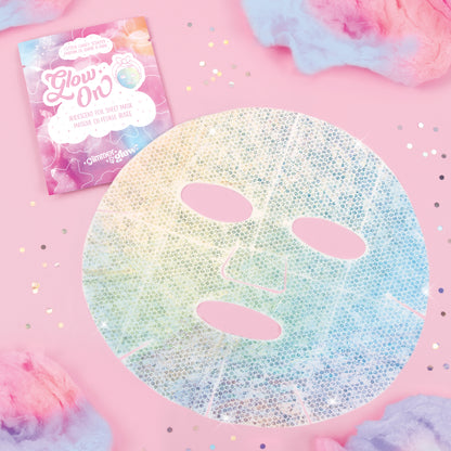 Glimmer & Glow iridescent foil sheet mask with three oval cutouts on pink background