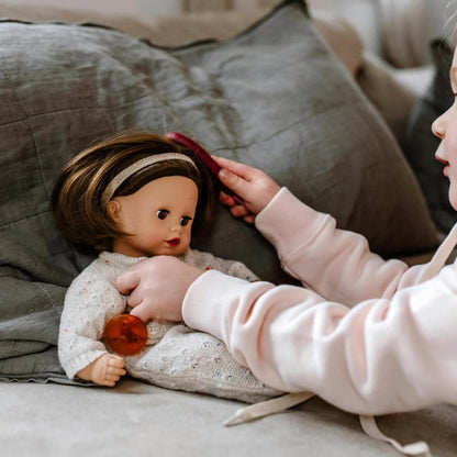 Muffin Doll 13" soft doll with brown hair, beige knit jumpsuit, headband, and pacifier