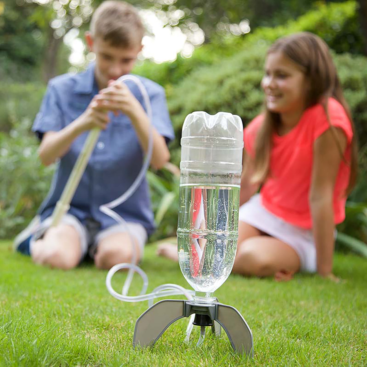 4M Water Rocket Bottle Launcher Kit with children playing outdoors on grass