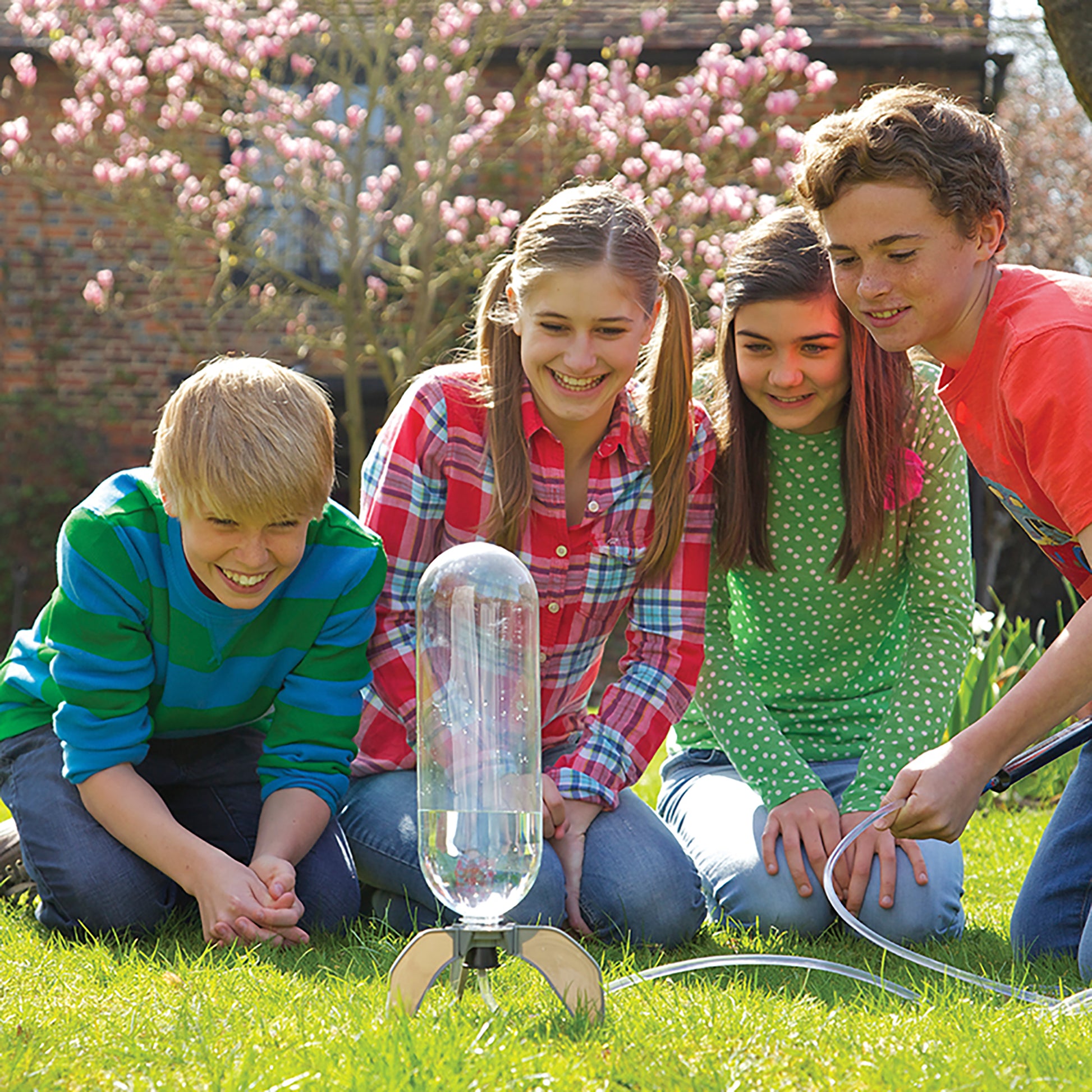 4M Water Rocket Bottle Launcher Kit with children launching clear rocket in garden