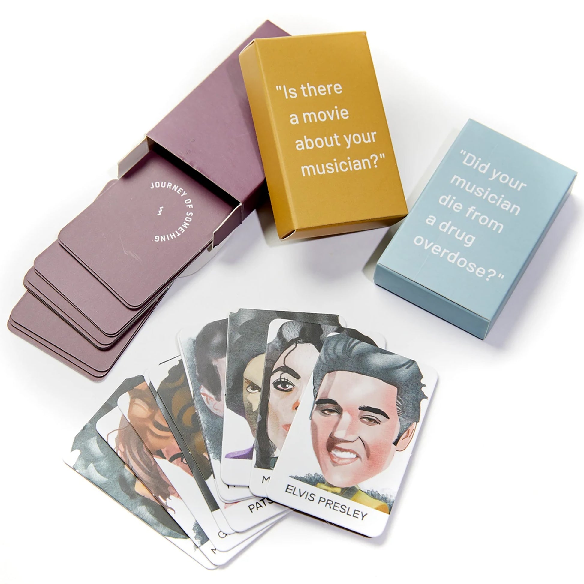 JOS Guess The Musician card game with purple boxes, yellow and blue card decks, and musician portrait cards