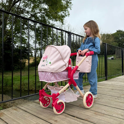 Roma RHS Single Doll Pram Flora in pink and red with girl playing outdoors