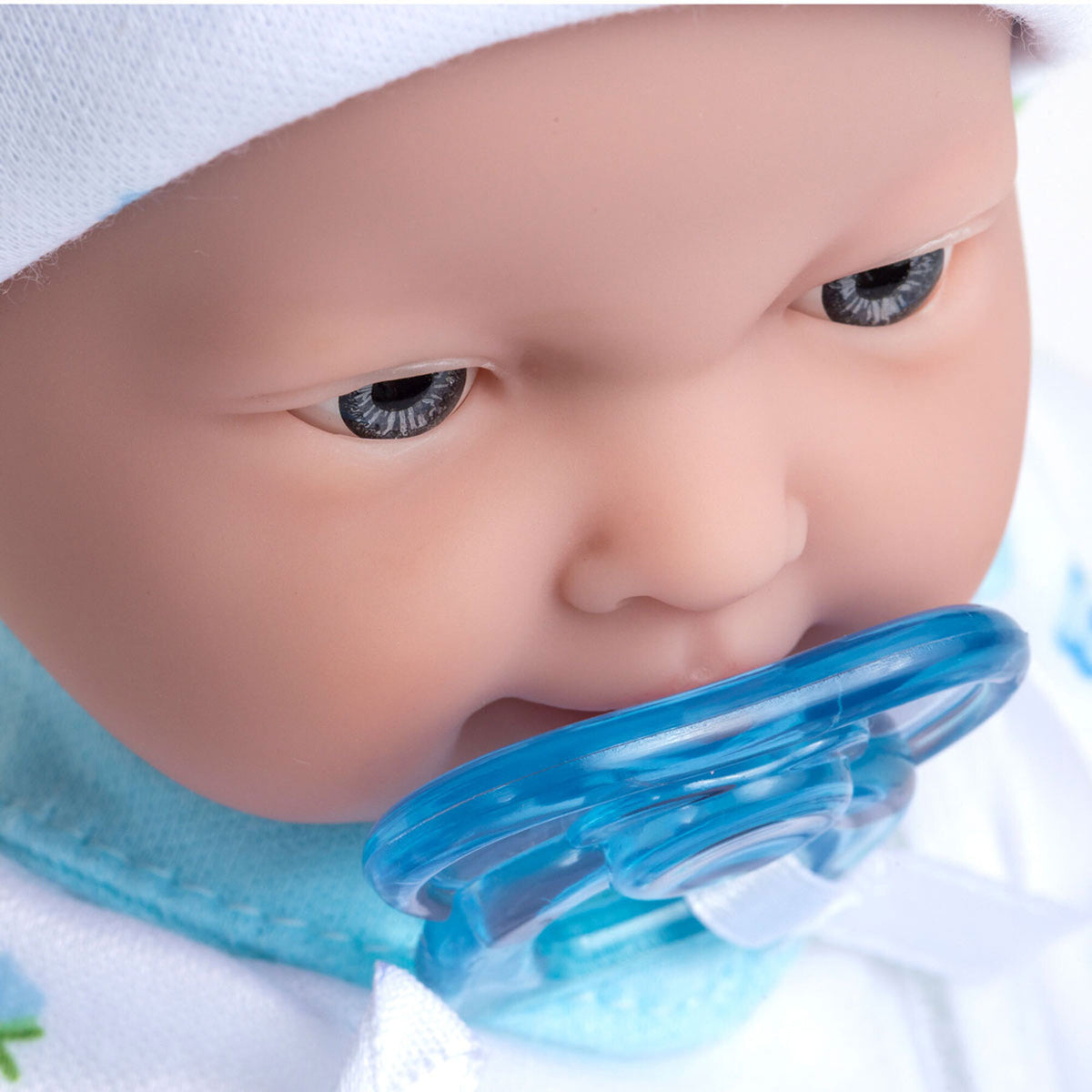 JC Toys La Baby doll with blue pacifier, white blanket, and blue outfit