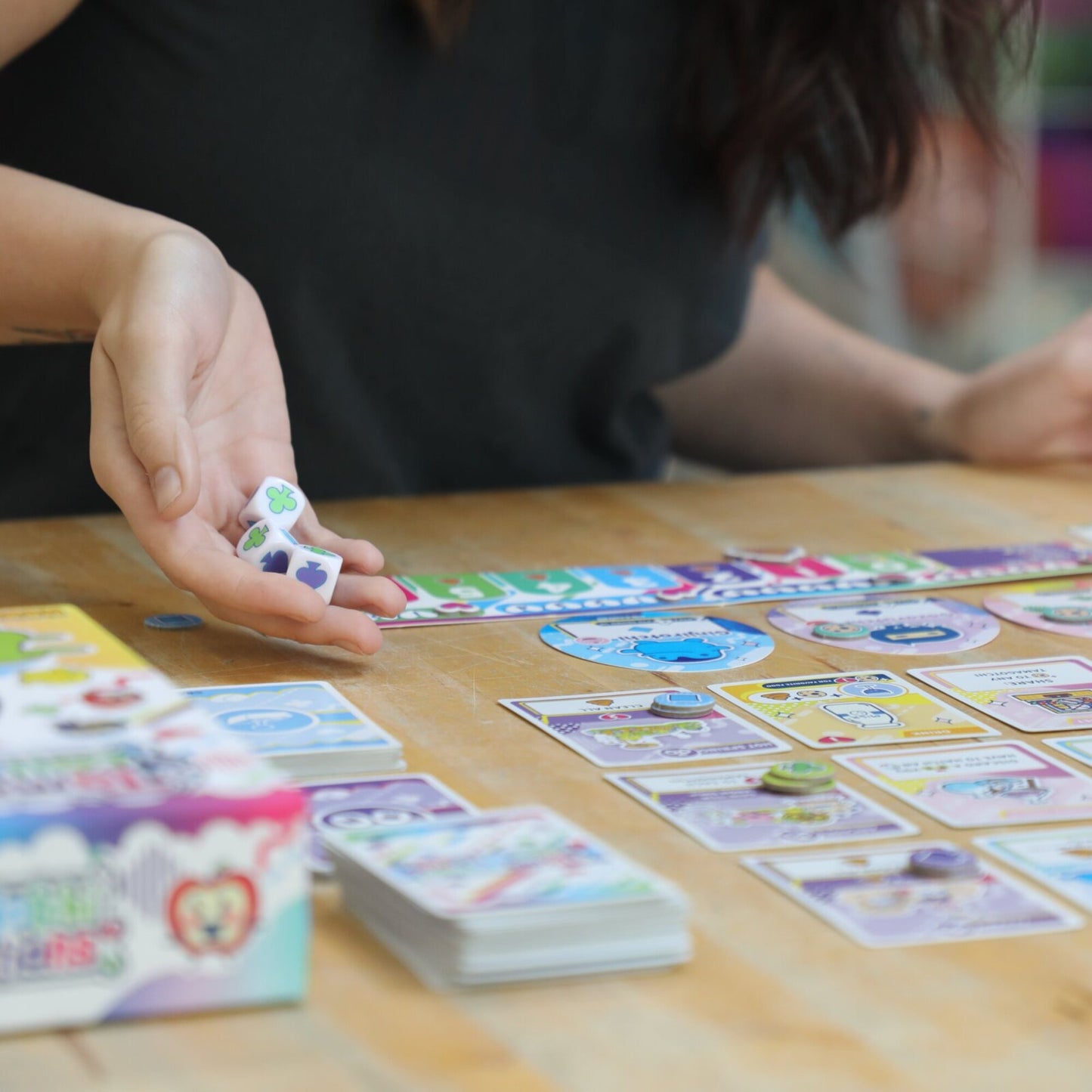 KESS Tamagotchi Collections board game with colorful cards and dice being played by children