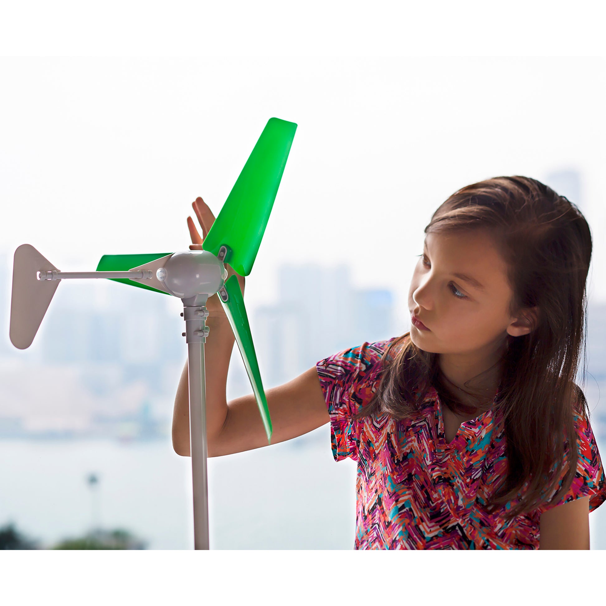 Green Science Wind Turbine with green blades and gray base held by child