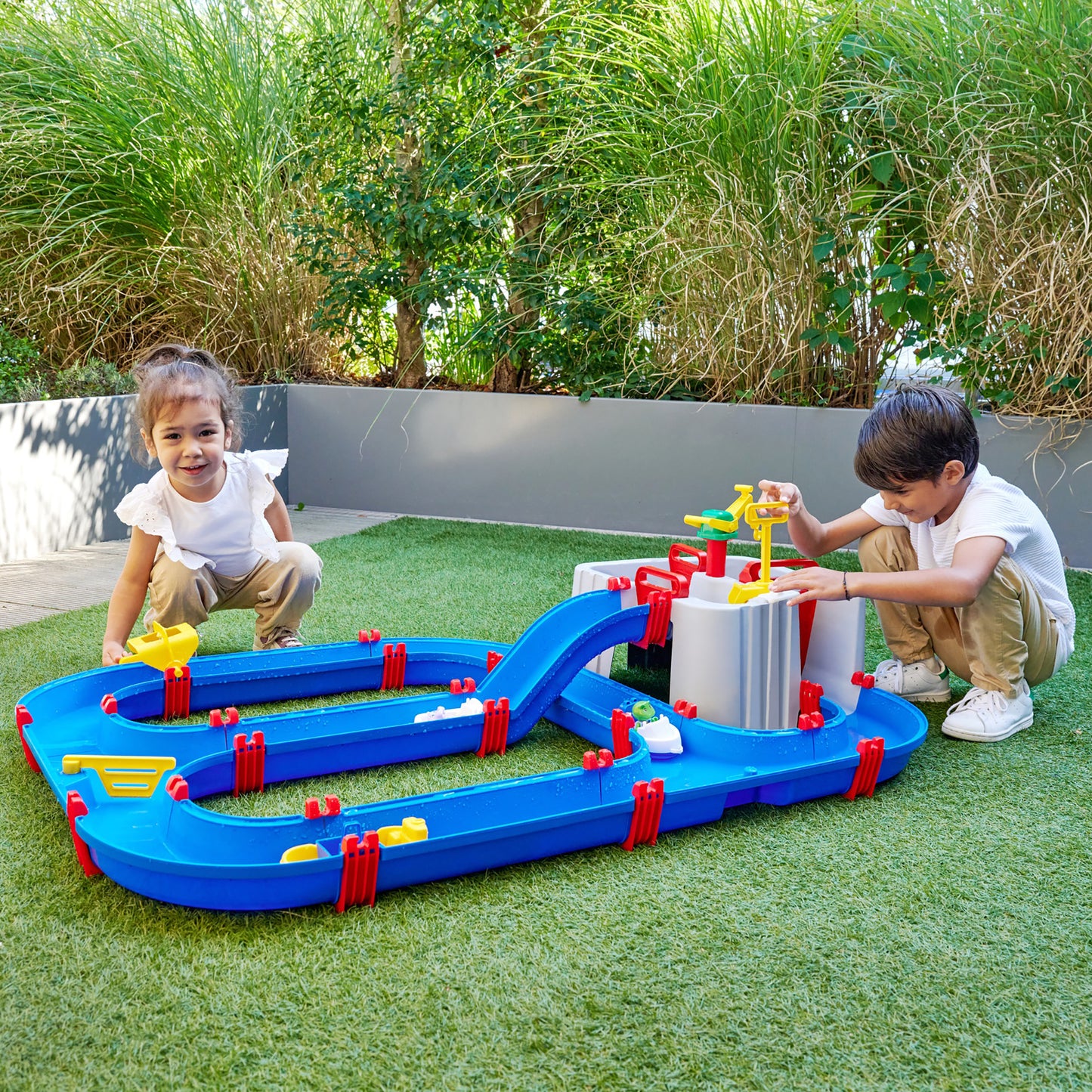 AquaPlay Harbor water toy set with blue tracks and red posts on artificial grass