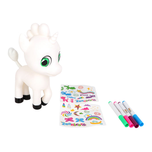 White unicorn figure with green eyes and black hooves, displayed with colorful markers and sticker sheets for customization