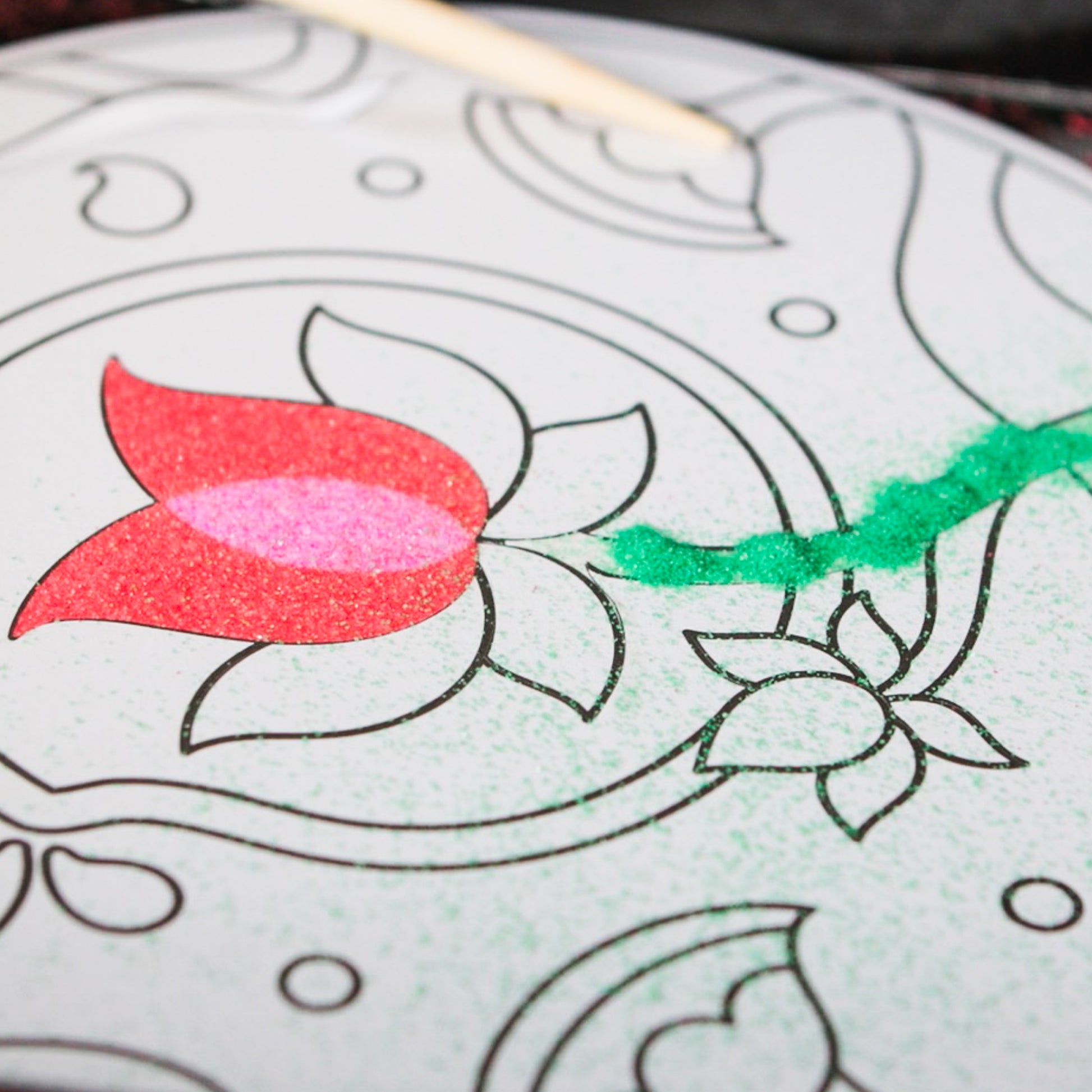 Rangoli Mandala Sand Art Kit with colored sand in red and green on white paper