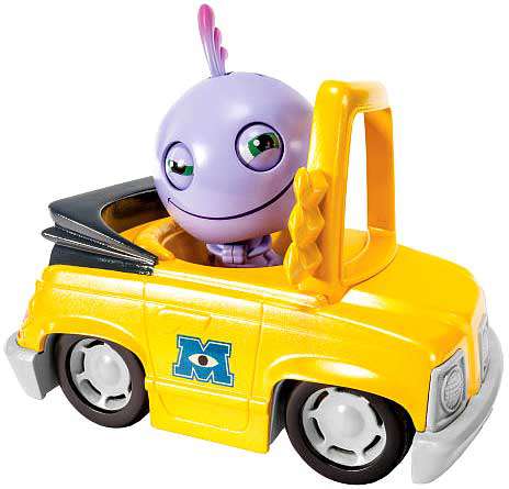 Purple Mike Wazowski figure with large eyes and pink feathers sitting in yellow toy car with books, part of Monsters University Roll A Scare game set