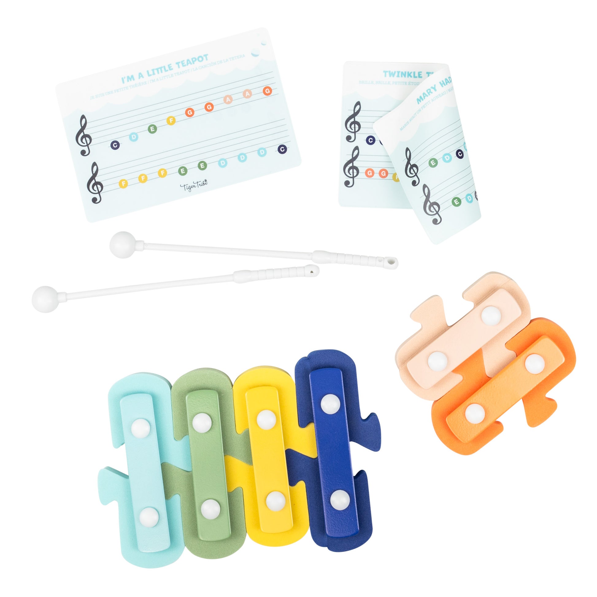 Tiger Tribe Bath Xylophone with colorful floating tiles in turquoise, green, yellow, and blue, white mallets, and instruction cards showing musical note pattern